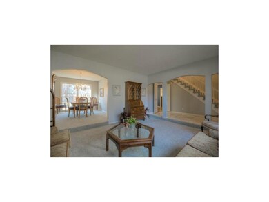 Living room flows into formal dining room. Both wi