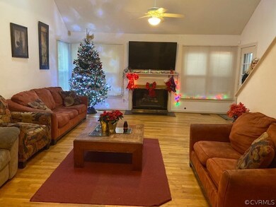 Hardwood floor & gas fireplace featured in spaciou