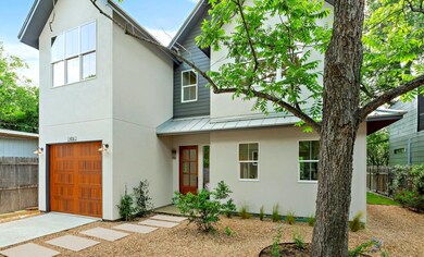 View of front facade featuring fence, a standing 