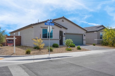 View of front of property featuring driveway, a ga