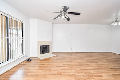 Spacious living room with wood flooring and a mode