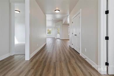 Hall featuring wood finished floors and baseboards
