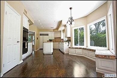 Large kitchen with rich hardwood floors.