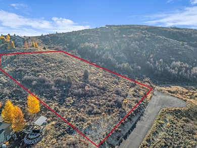 Aerial view of property and surrounding area featuring property boundaries highlighted