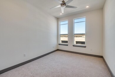 Carpeted spare room with ceiling fan