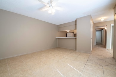 Spare room with ceiling fan, baseboards, and light