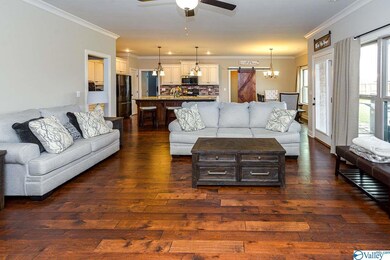 boasts more of those exquisite hardwood floors, along with crown molding, a ceiling fan, & a gas fireplace. A patio door between the Kitchen and Great Room easily transitions dinner guests to outdoor entertaining.