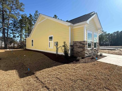 View of side of home with stone siding and roof wi