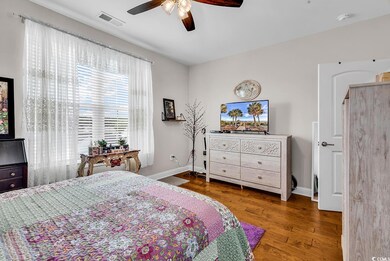 Bedroom with wood finished floors, baseboards, and ceiling fan
