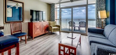 Living room featuring a ceiling fan, floor to ceiling windows, and wood finished floors