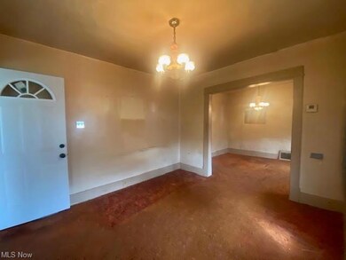 Living room with a notable chandelier and concrete