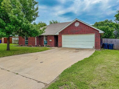 Ranch-style home featuring a garage and a front lawn