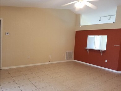 Living Room facing kitchen pass through window.