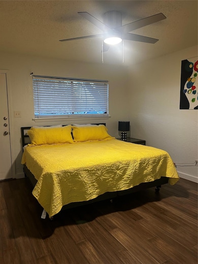 Bedroom with wood finished floors, ceiling fan, a