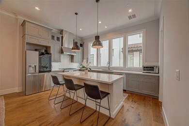 Island kitchen features Miele appliances, breakfas