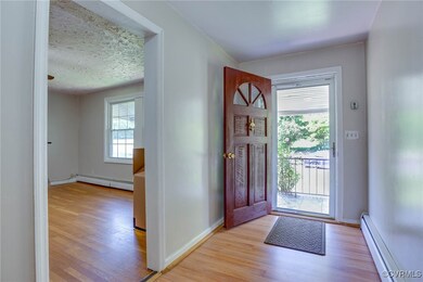 Foyer featuring a textured ceiling, baseboard heat