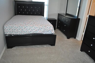 Bedroom with light carpet