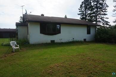 View of property exterior featuring a lawn