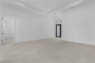 Spare room with a tray ceiling, recessed lighting,