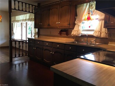 Main home kitchen offers lots of cabinets. Dining room has large bay window with an awesome view of the front yard.
