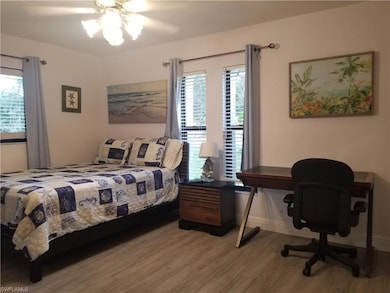Bedroom featuring hardwood / wood-style flooring and ceiling fan