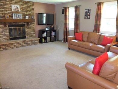 Living room with wood burning fireplace.
