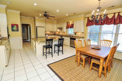 The gourmet kitchen is a chef's dream and opens to
