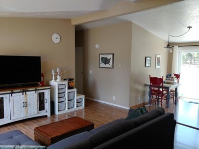 Living, dining room w/ vaulted ceilings