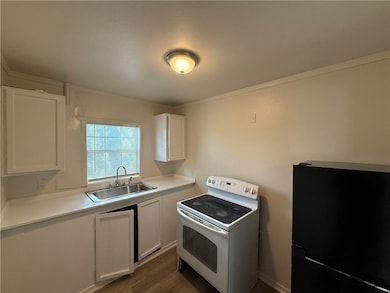 Kitchen featuring freestanding refrigerator, white