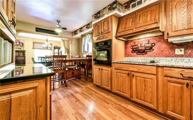 Kitchen features gleaming hardwood floors.