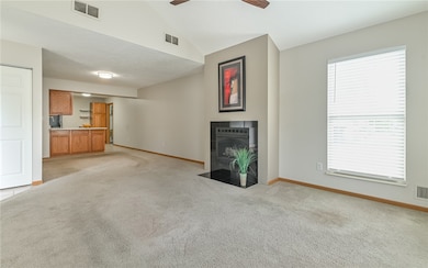 Open floor plan with neutral color tones and updated light fixtures with LED bulbs throughout.