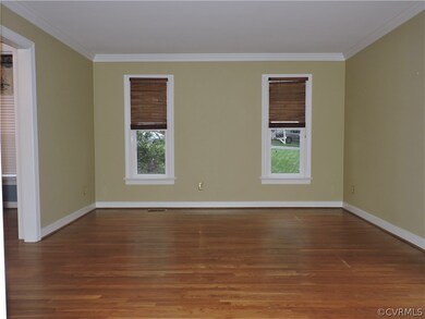 Formal Living Room with crown molding, blinds & wo