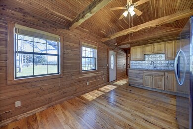 Kitchen with light wood-type flooring, wood walls,