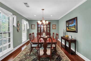 Dining space with baseboards, visible vents, a cha
