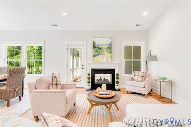 Living area featuring recessed lighting, a multi sided fireplace, and wood finished floors