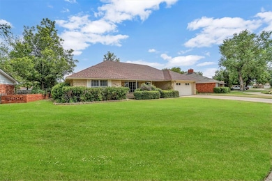 Single story home featuring a garage and a front l