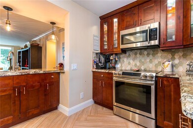 Open kitchen into dining and living area giving ea