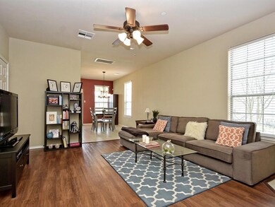 Living room with dark wood finished floors, baseb