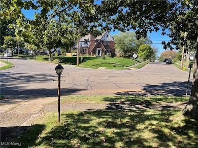 View of asphalt street featuring traffic signs and curbs