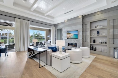 Living room featuring wood ceiling, built in shelv