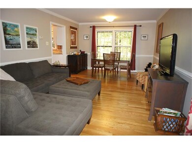 The lovely living room opens to the dining area wi