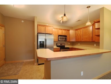 The kitchen contains stainless steel appliances an