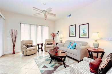 Living room featuring visible vents, ceiling fan, 