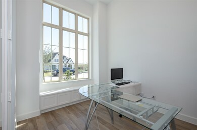 Bright home office with large windows, offering plenty of natural light. 