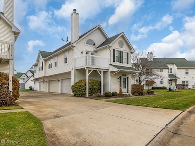View of front of house featuring a front yard, driveway, a residential view, an attached garage, and a chimney