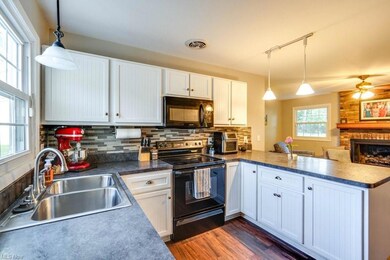 Kitchen featuring rail lighting, white cabinetry, 