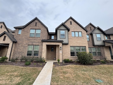 Townhome / multi-family property featuring a front