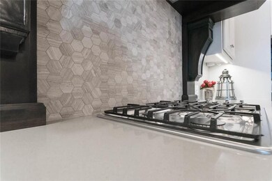Kitchen Features Quartz Counter Top, Gas Cook Top,