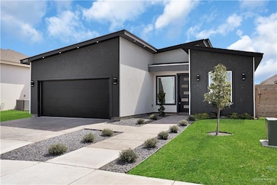 Contemporary house with a garage, stucco siding, and driveway