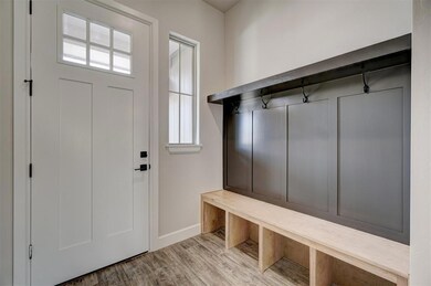 Mudroom with light hardwood / wood-style flooring